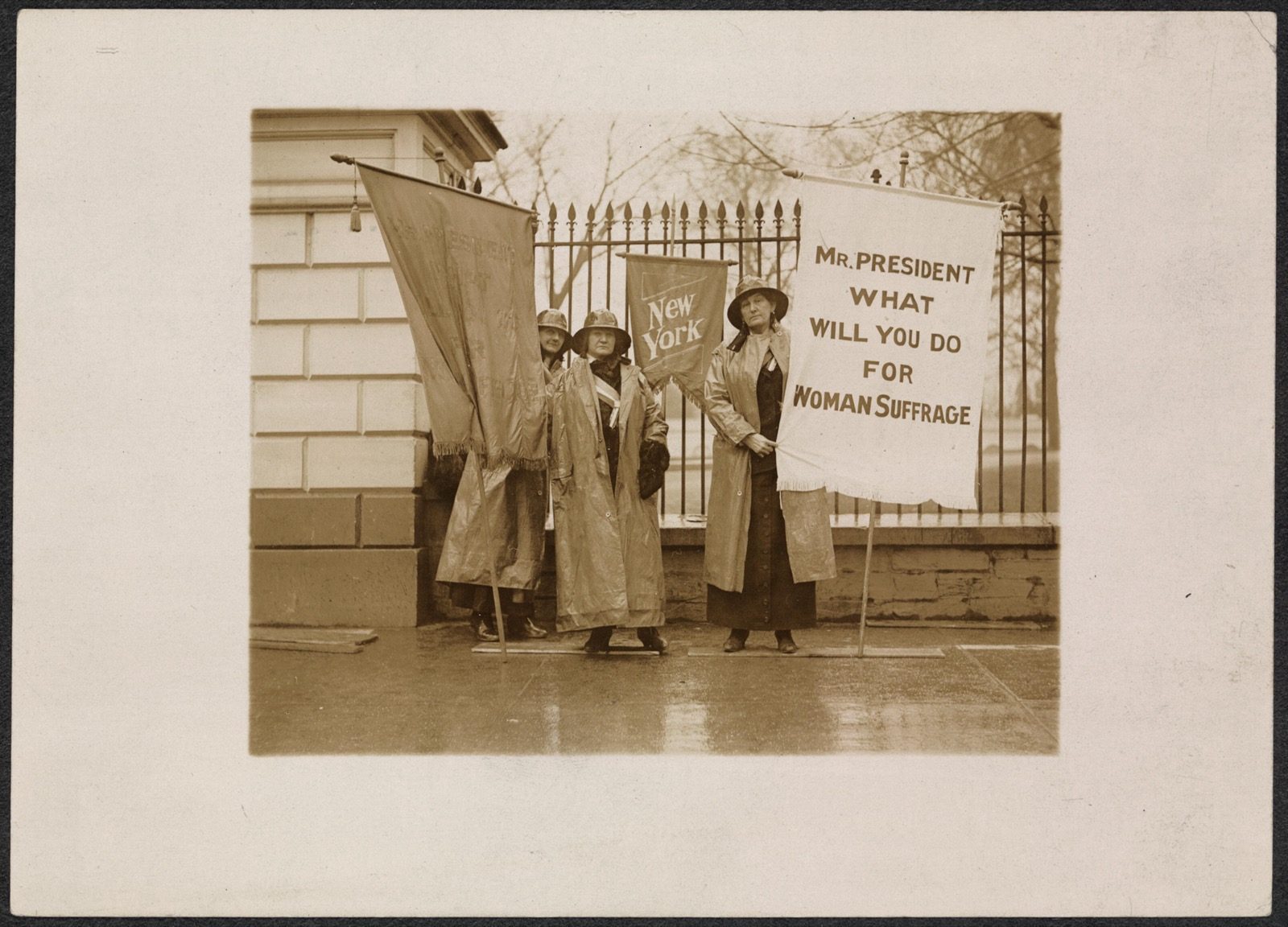 National Woman's Party pickets holding banners in the rain outside the White House, 26 January 1917